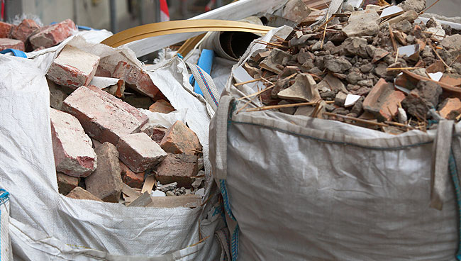 photo of demolition debris junk removal in canvas bags ready for pickup